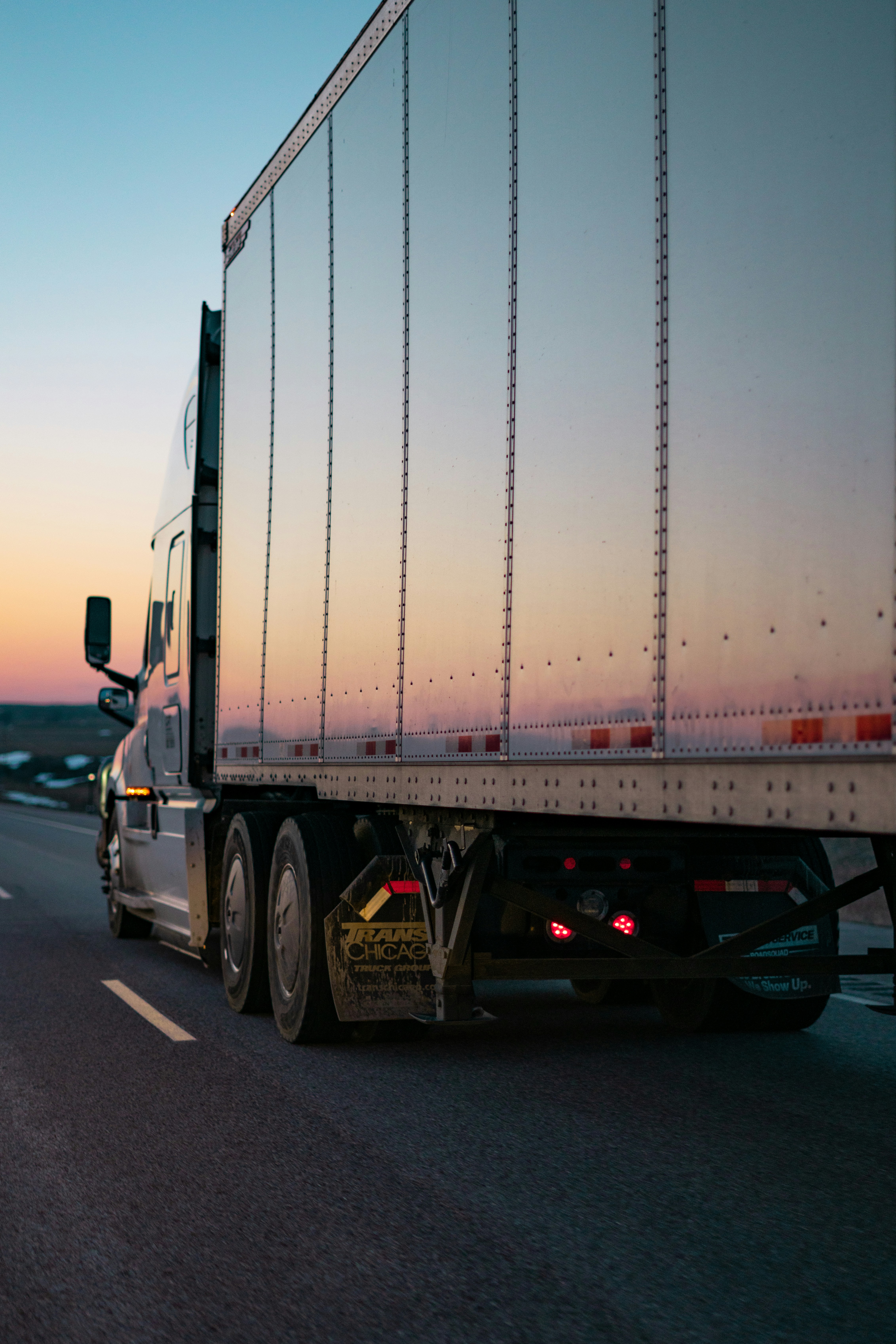White freight truck moving through a logistics route